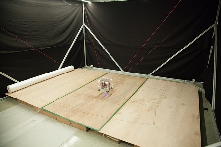   
		Figure 2: Portable cable-driven robot system within a 4m x 4m setup	 
